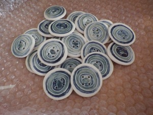 Ceramic buttons... with a tiny leaf motif in the middle of each